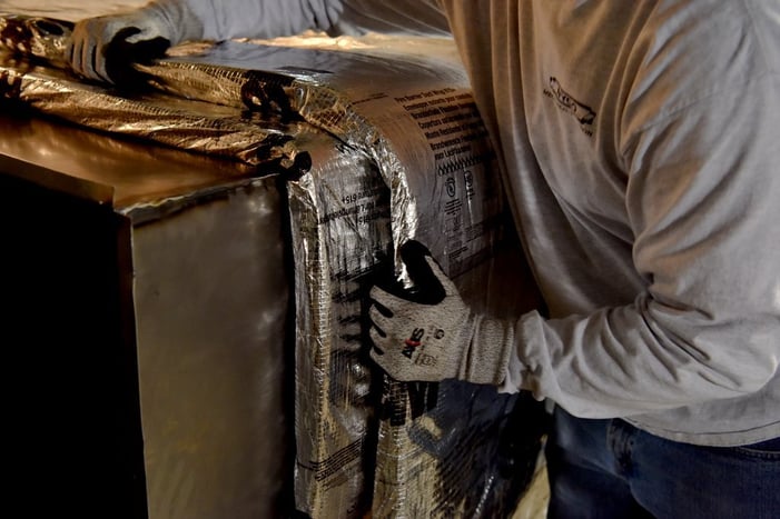 A person installing 3M Fire Barrier Duct 